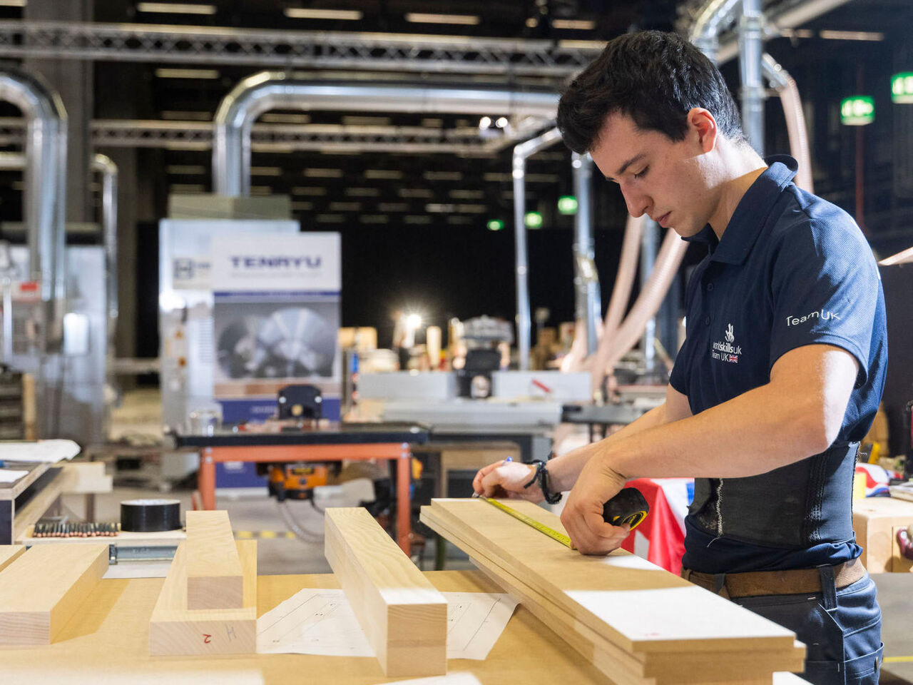 A British competitor in WorldSkills Competition 2022 Special Edition measures wood with a measuring tape at Holz, Switzerland’s woodworking sector trade fair, at Messe Basel, Switzerland from 11 to 14 October.
