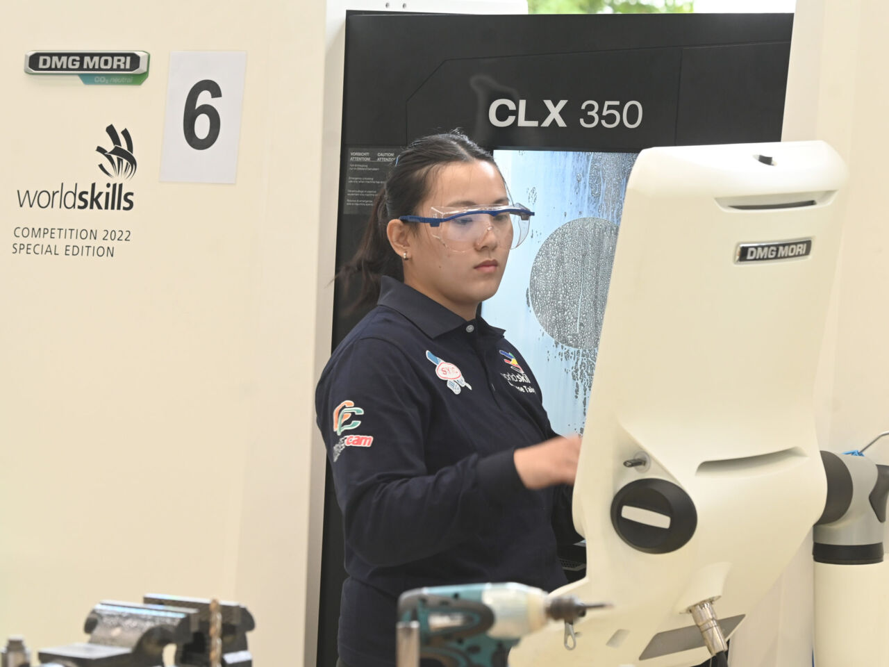 A female WorldSkills Competitor programming a CNC machine in the DMG MORI’s showroom in Leonberg, Germany. 
