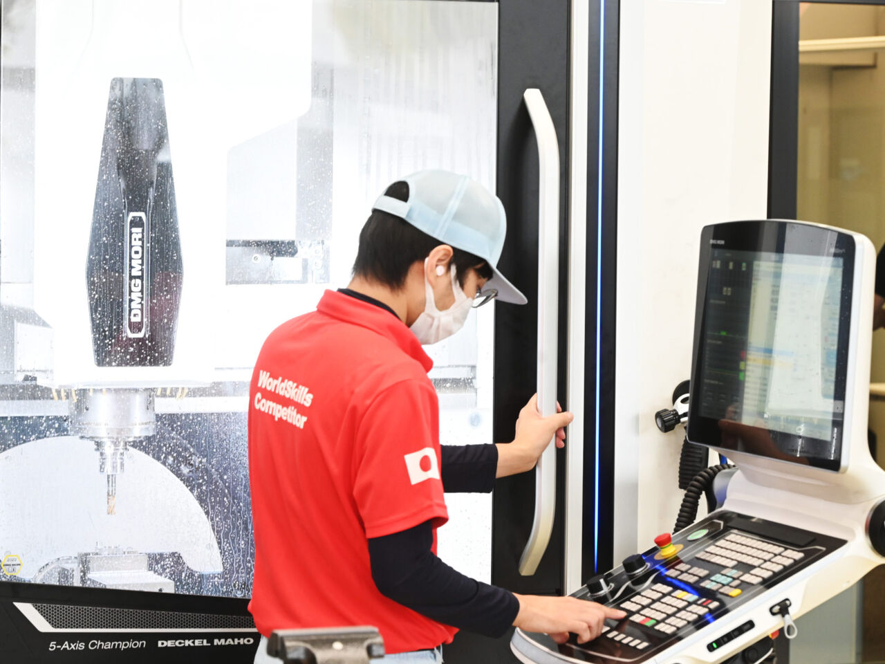 A male WorldSkills Competitor programming a CNC machine in the DMG MORI’s showroom in Leonberg, Germany. 
