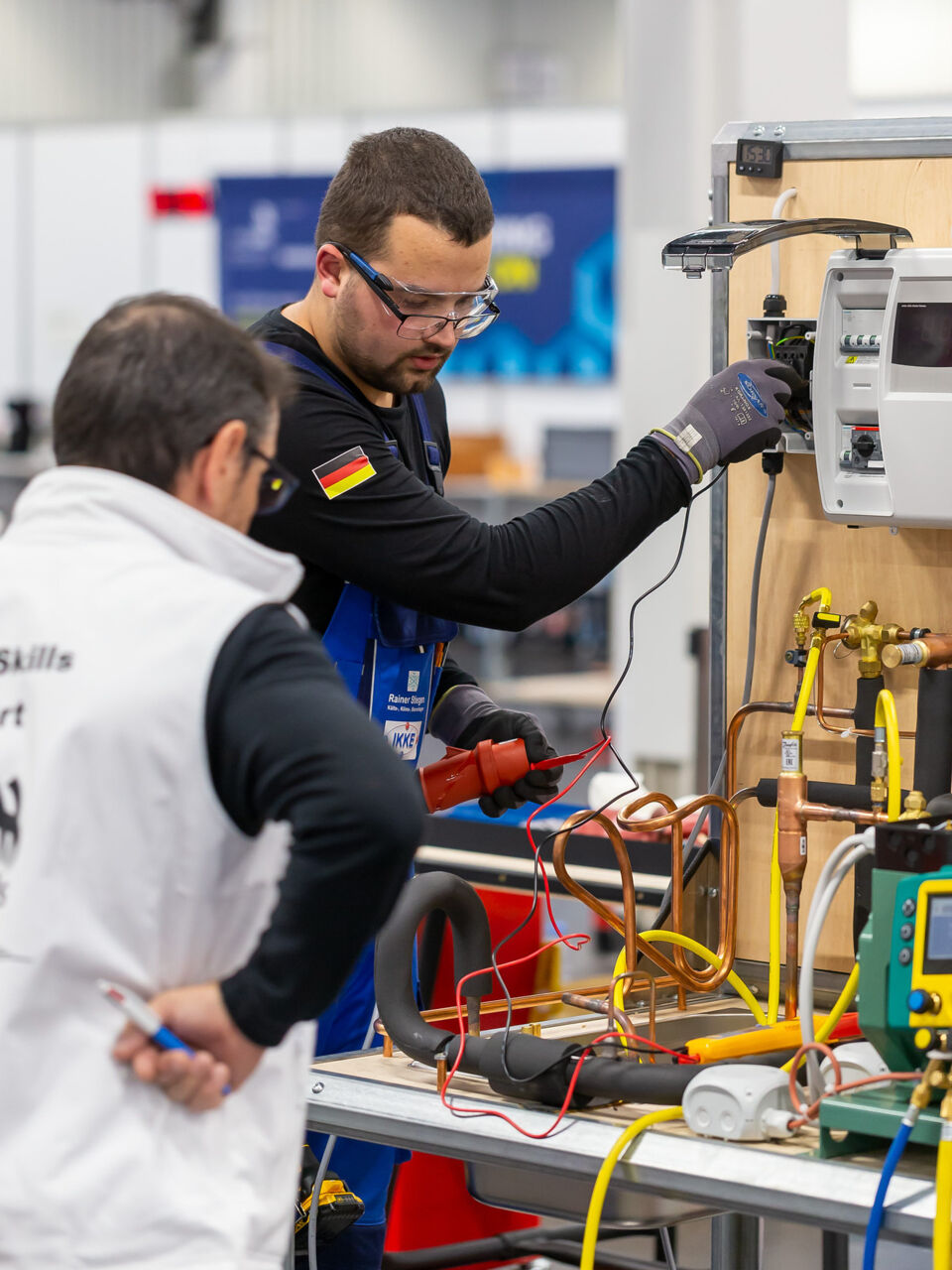 A Refrigeration and Air Conditioning Competitor from Germany testing electrical equipment in Nuremberg, Germany as part of WorldSkills Competition 2022 Special Edition.