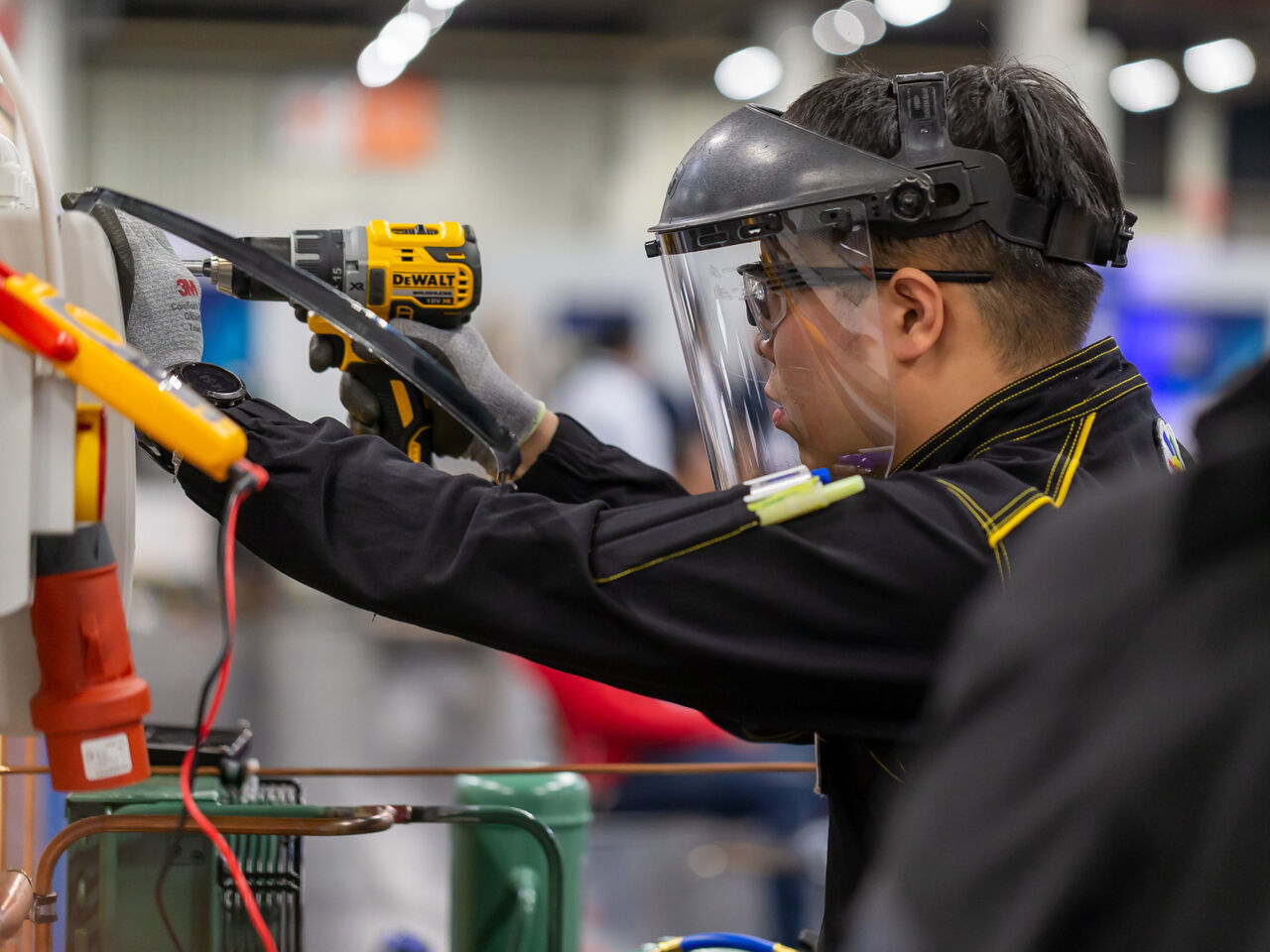 A Refrigeration and Air Conditioning Competitor working on an electrical distribution box in Nuremberg, Germany as part of WorldSkills Competition 2022 Special Edition.